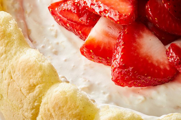 Close-up shot of Pineapple Cheesecake; chopped strawberries on top;