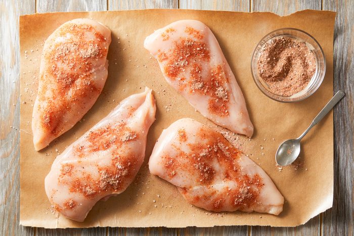 Paprika, salt, pepper, garlic powder and cayenne sprinkled on all sides of the chicken breasts