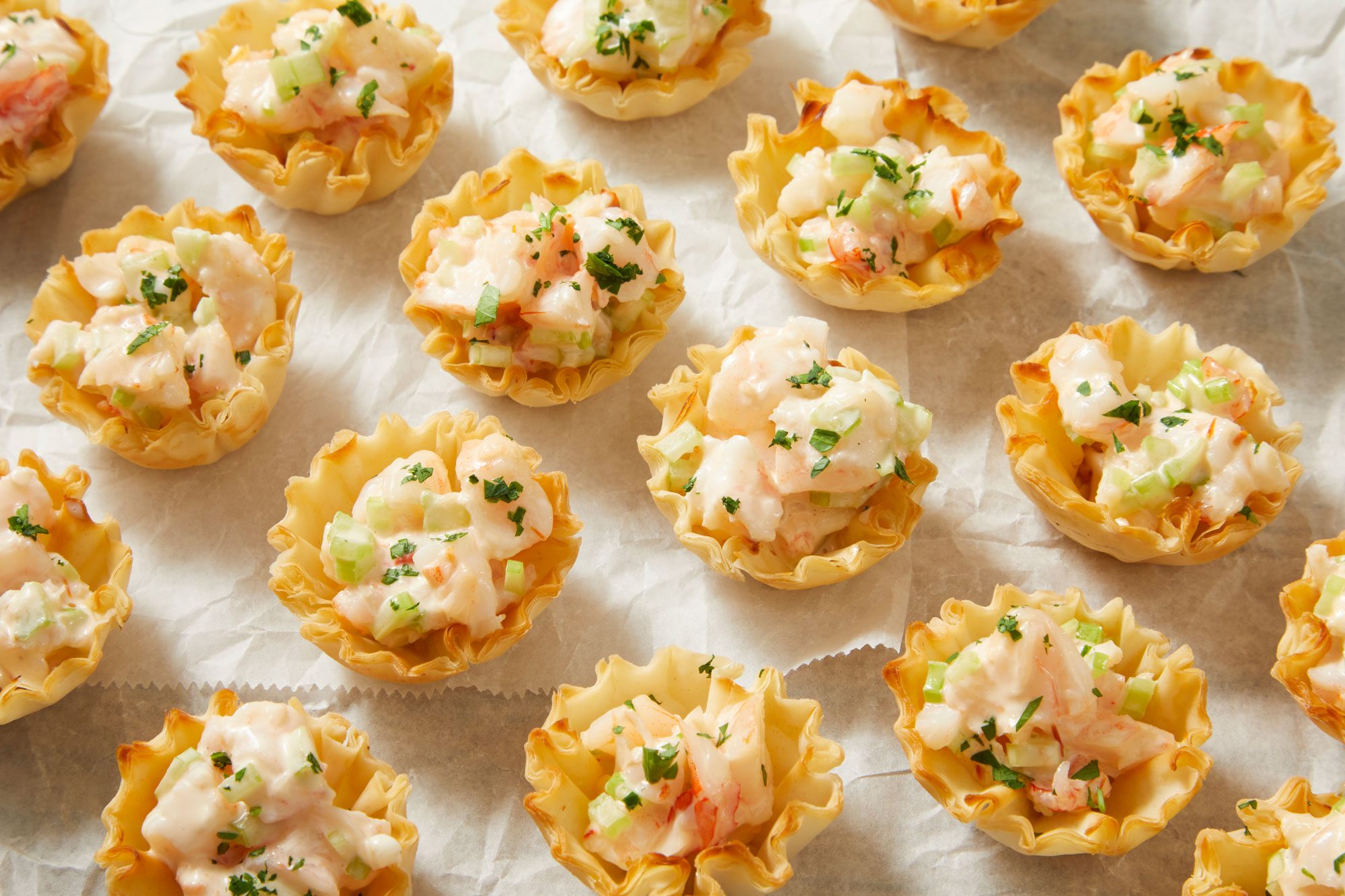 3/4th shot of Shrimp in Phyllo Cups arranged on a sheet of parchment paper