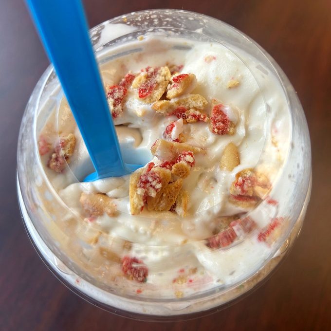 Close-up of Wendy's frosty with mix-ins and a blue spoon