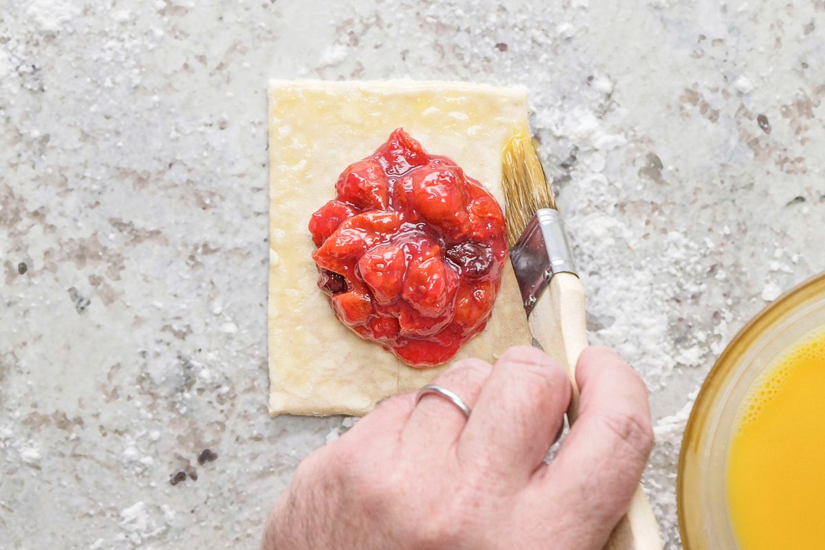 brushing dough with egg wash