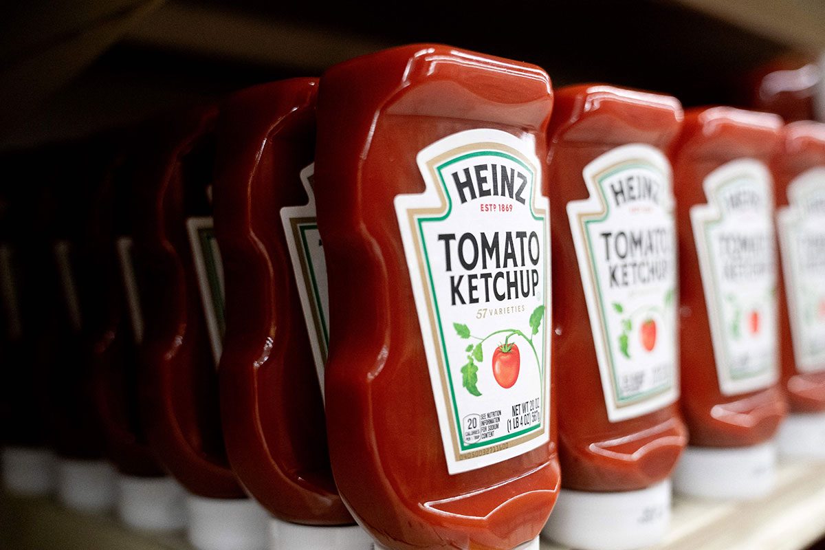 Heinz ketchup is displayed on a shelf at a grocery store