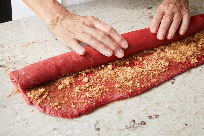 dough being rolled up jelly-roll style