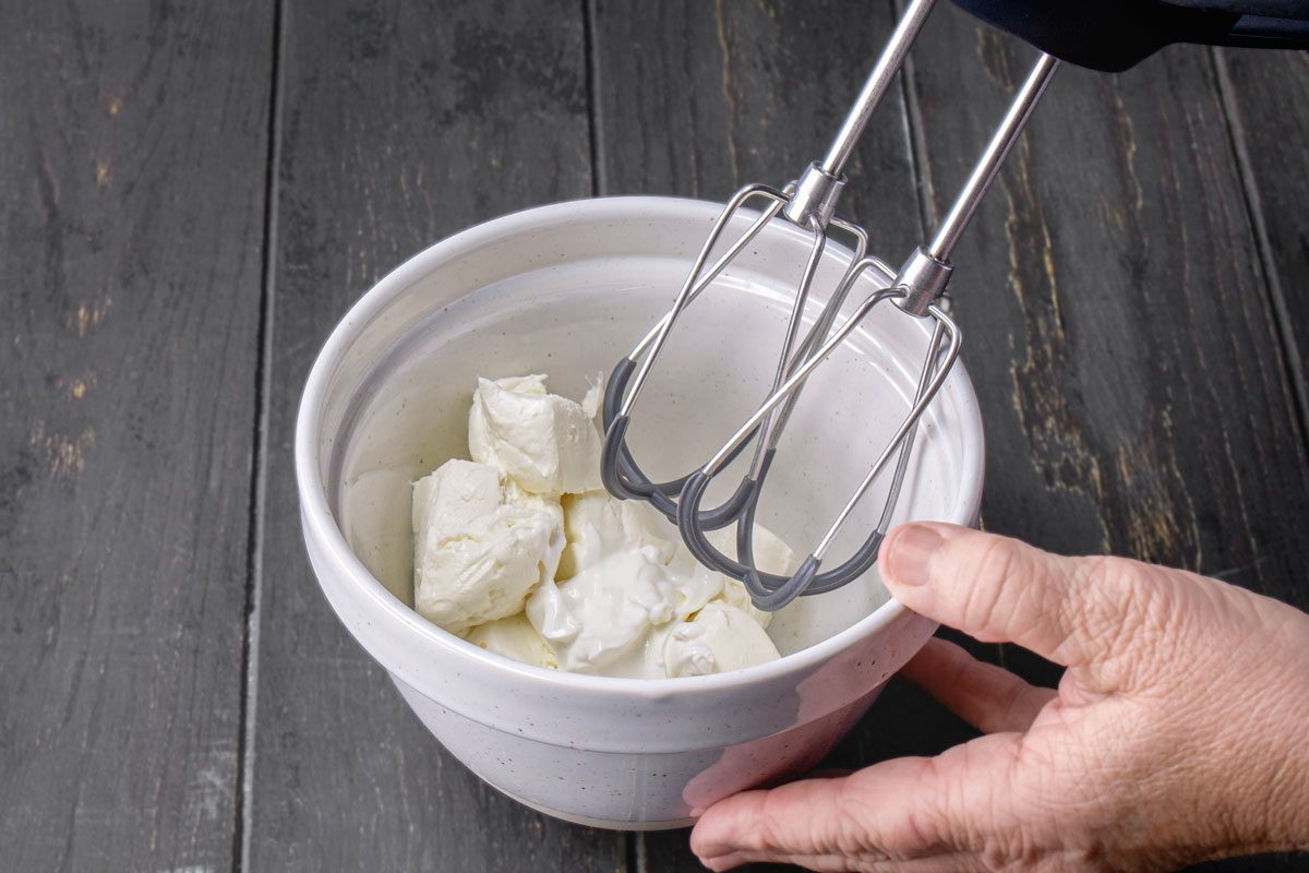 In a small bowl, beat cream cheese and sour cream until blended.