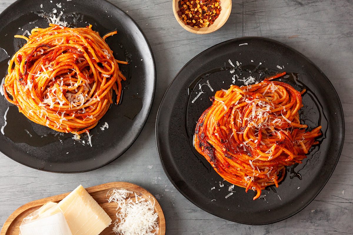 Spaghetti all'Assassina is ready and served in plates and prinkle with grated Pecorino Romano or Parmesan cheese; if desired; Serve hot