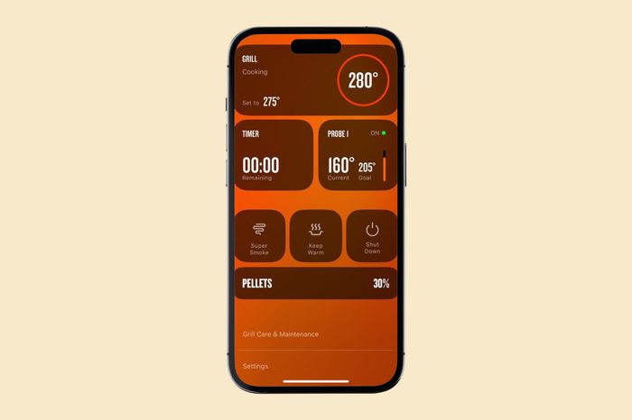 A smartphone displaying a grilling app interface with orange tones, showing grill temperature at 280°F, timer at 00:00, probe temperature at 160°F, and various control options below.