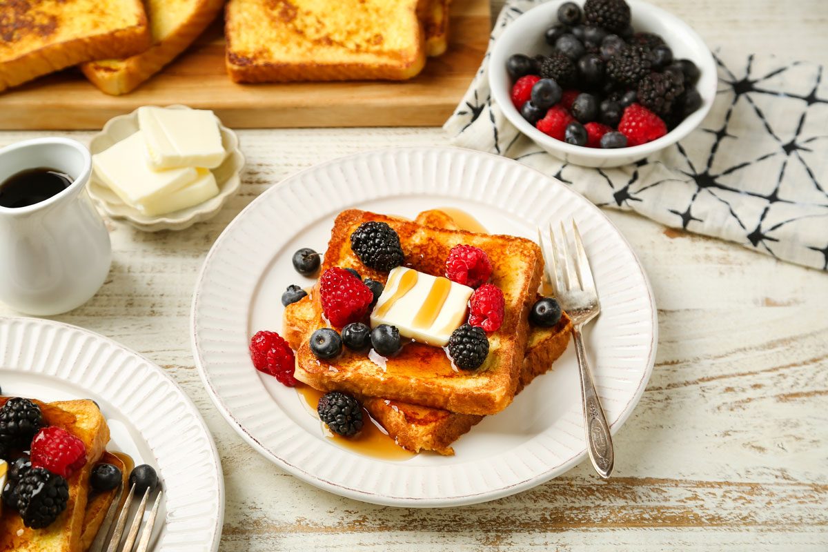 Vanilla French Toast is ready and served with berries; butter and maple syrup