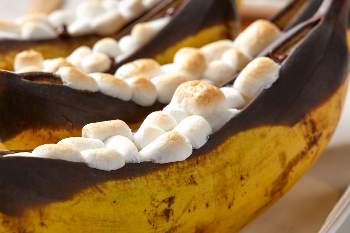 Closeup shot of Banana Boats served on white plate;