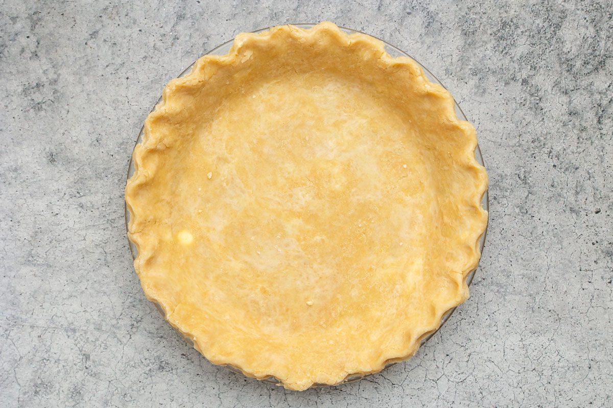placed pie crust into pie pan, overhead shot