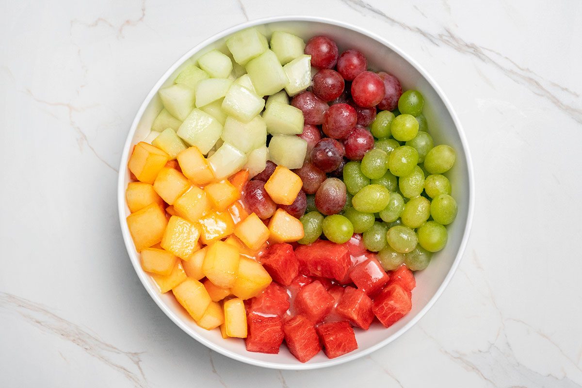 Sugar with the lemon, lime and orange juices poured over mixed fruits
