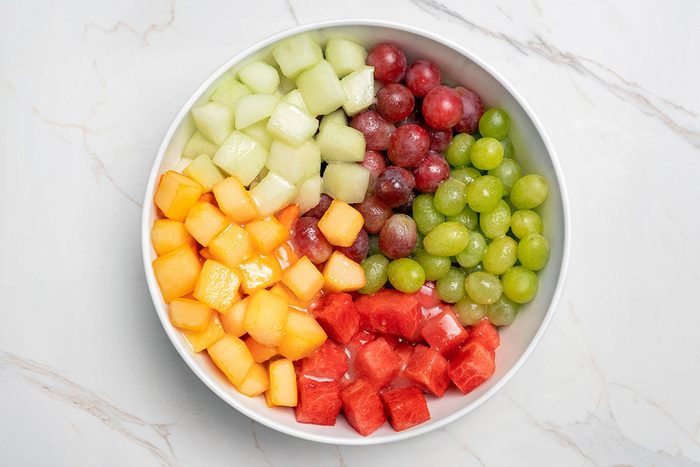 Sugar with the lemon, lime and orange juices poured over mixed fruits