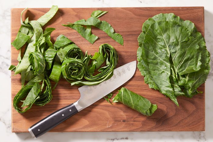 Remove thick stems. Stack and roll up collards