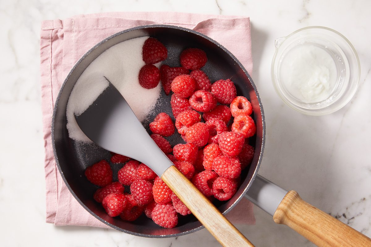 raspberries and sugar in a saucepan