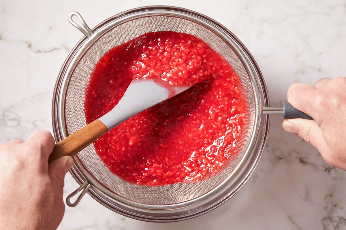 straining solids from raspberry swirl