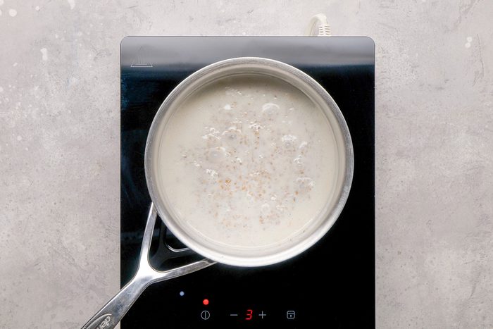 oats and milk being cooked in a pan