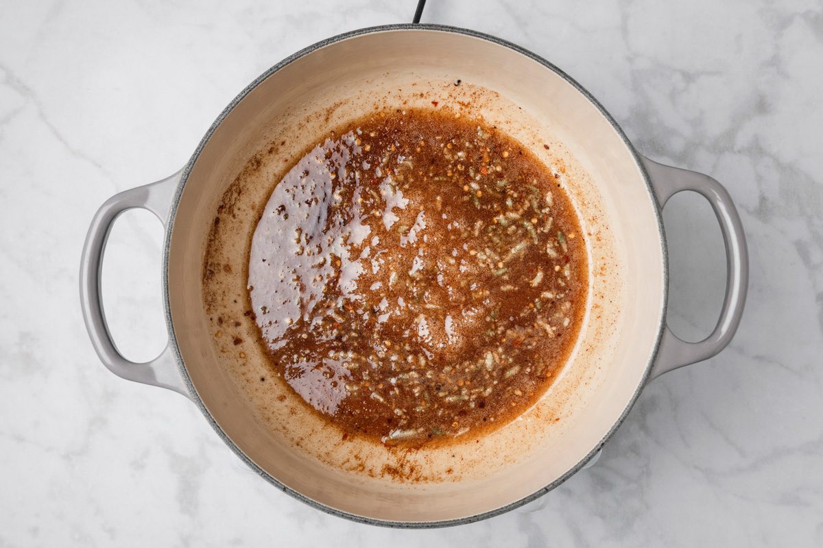 sugar, cider vinegar, minced garlic, ground ginger, ground cumin, ground cinnamon, crushed red pepper flakes and ground cloves mixed in a large saucepan