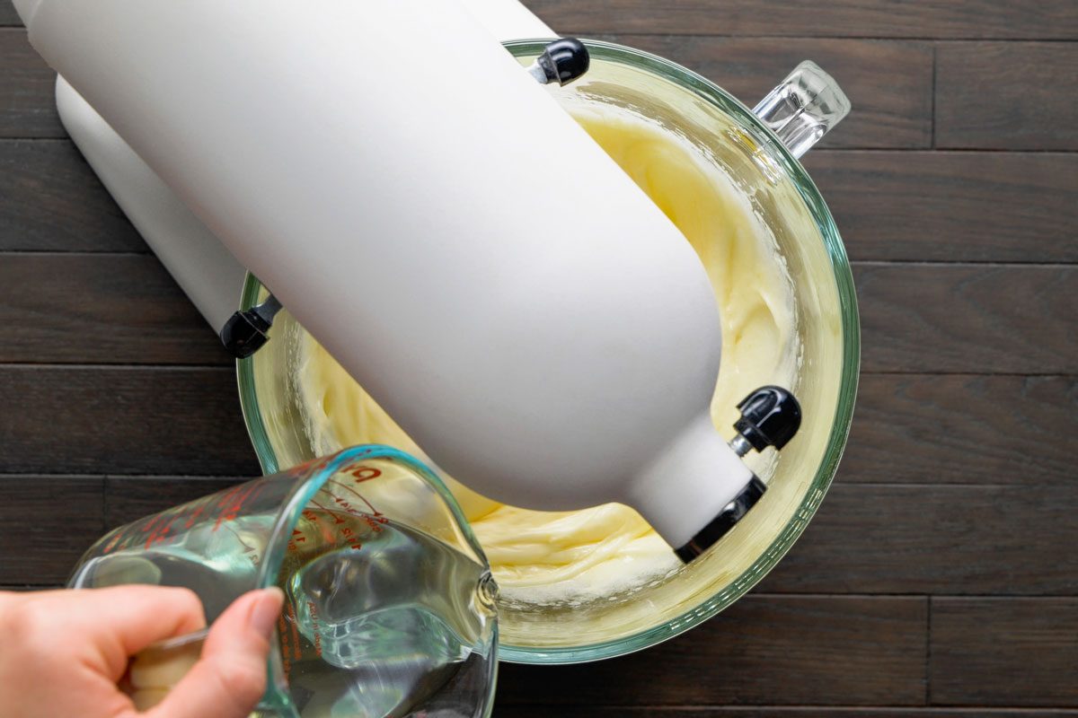 Overhead shot of gradually beat in oil; all set on a dark brown wooden surface;