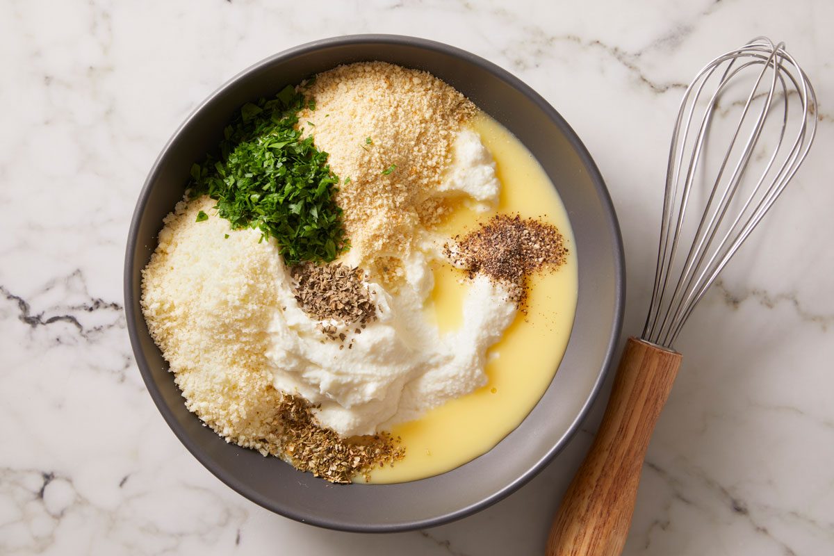 In a large bowl, combine ricotta, egg substitute, 3 tablespoons bread crumbs, 3 tablespoons Parmesan, parsley, oregano, basil and pepper;