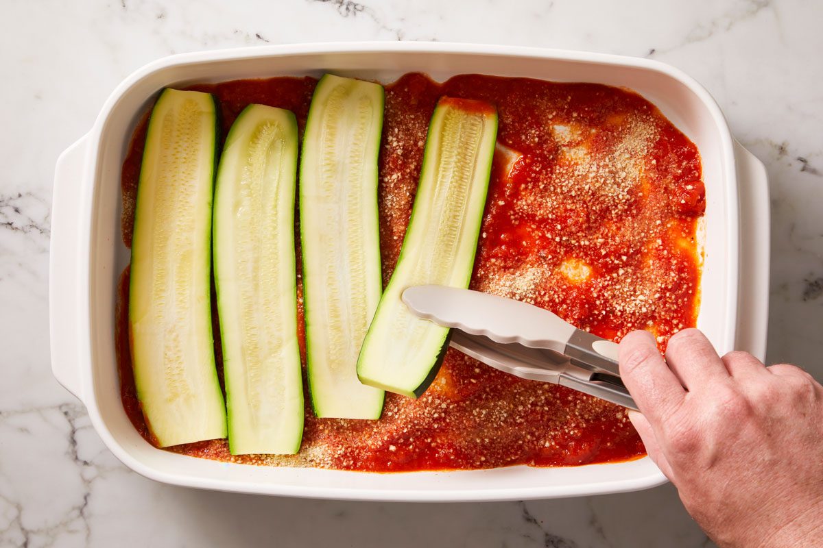 Spread a third of the spaghetti sauce in a 13x9-in. Cover with half each zucchini, ricotta mixture and mozzarella.
