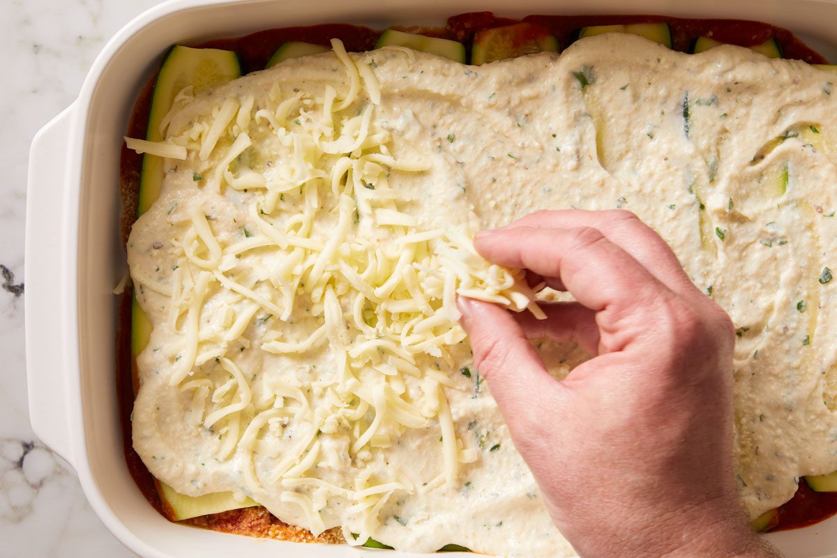 Repeat layers of sauce, zucchini, ricotta mixture and mozzarella.