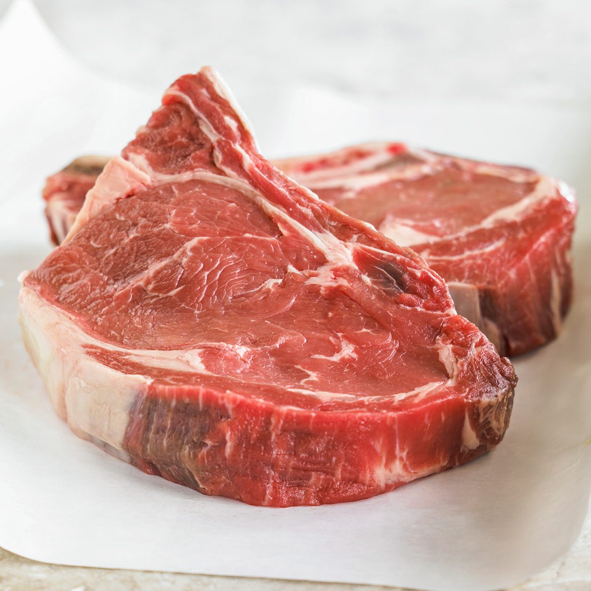 Raw beef on parchment paper