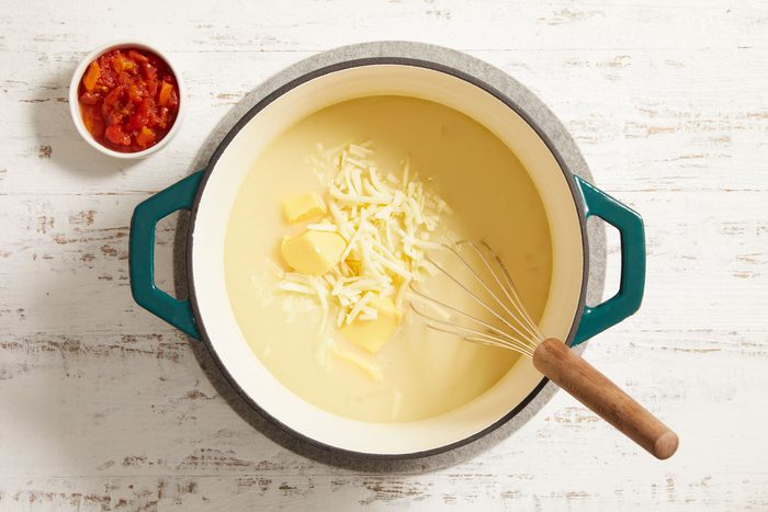 Add the tomatoes, Velveeta and 1 cup Monterey Jack