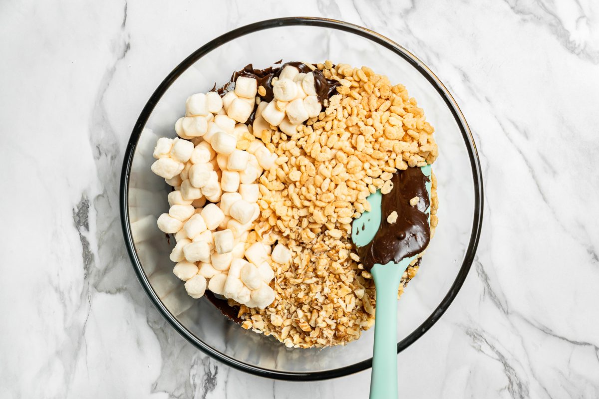 marshmallows, cereal and walnuts added to chocolate chips mixture
