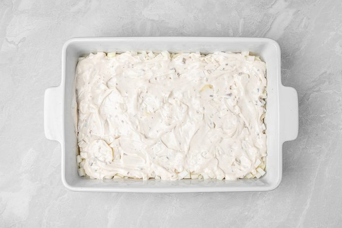 layers of sliced potatoes and chopped onions sprinkled with salt and pepper