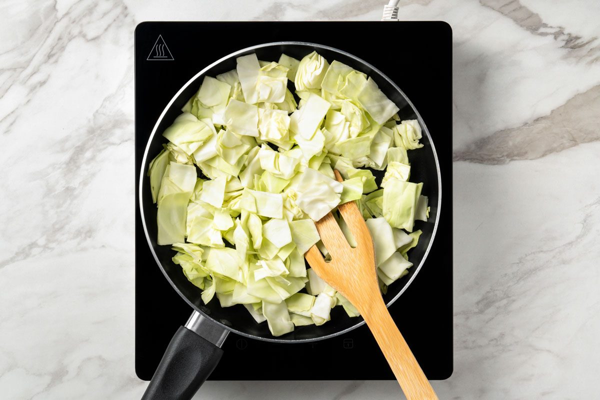 In a large nonstick skillet or wok, stir-fry cabbage