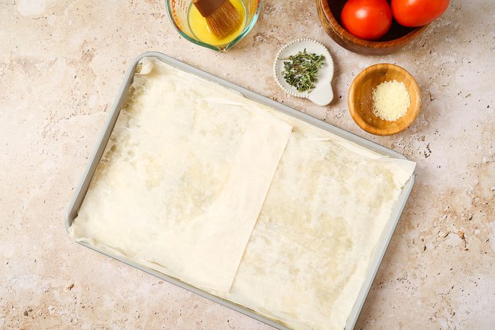 bottom and sides of the prepared pan lined with two sheets of phyllo dough