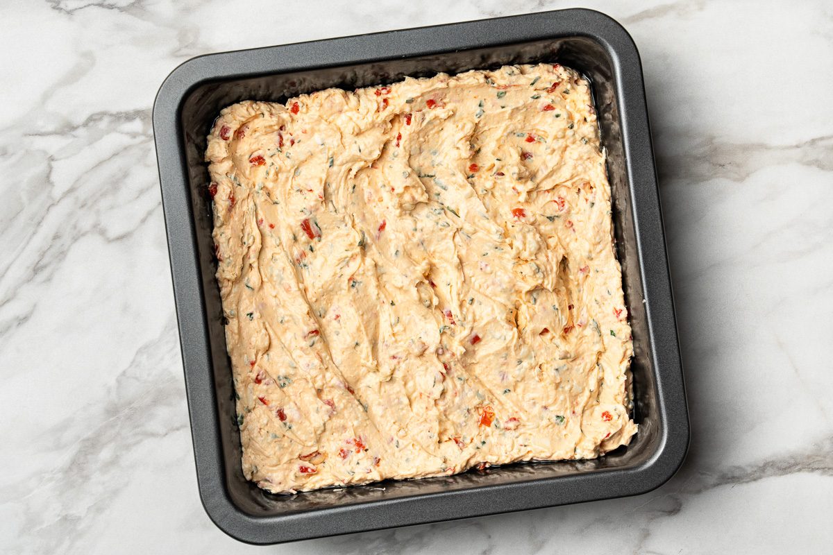 cream cheese, feta cheese, red peppers and basil mixture in baking dish