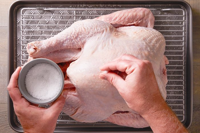 salt being sprinkled on turkey