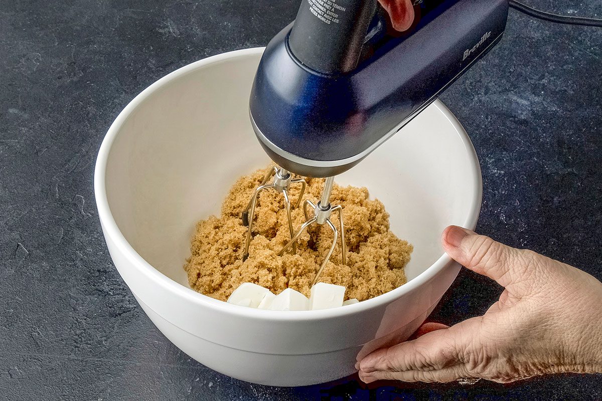 High angle shot of a large bowl; cream shortening and brown sugar until light and fluffy 5-7 minutes; Beat in egg and vanilla; blender; dark surface
