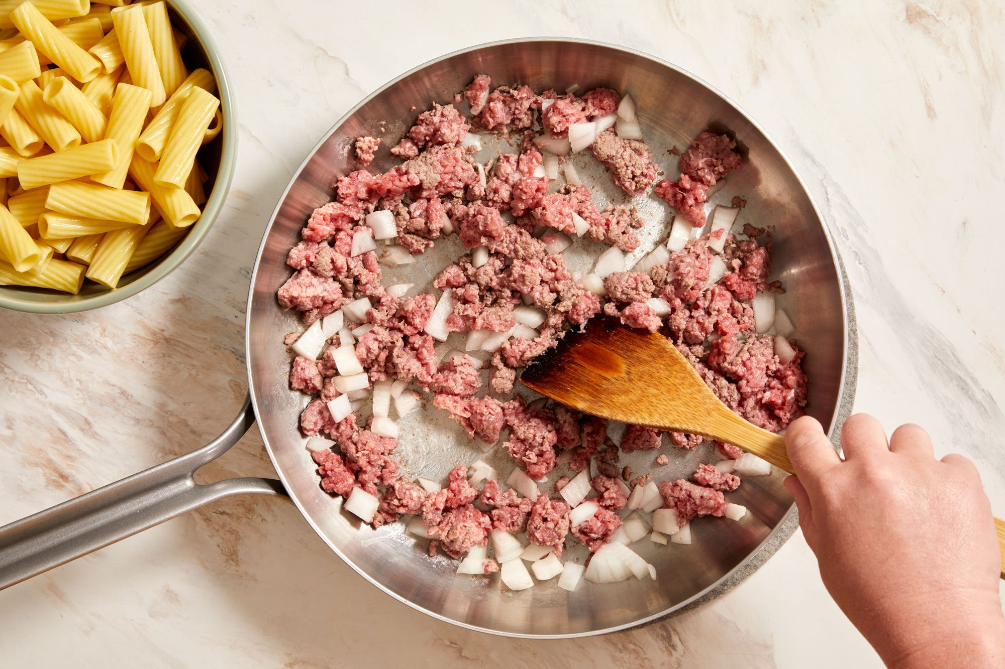 cook beef and onion in a large skillet until beef is no longer pink,