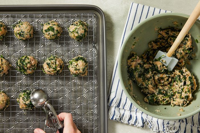 Shaping the mixture into balls to make Chicken Florentine Meatballs