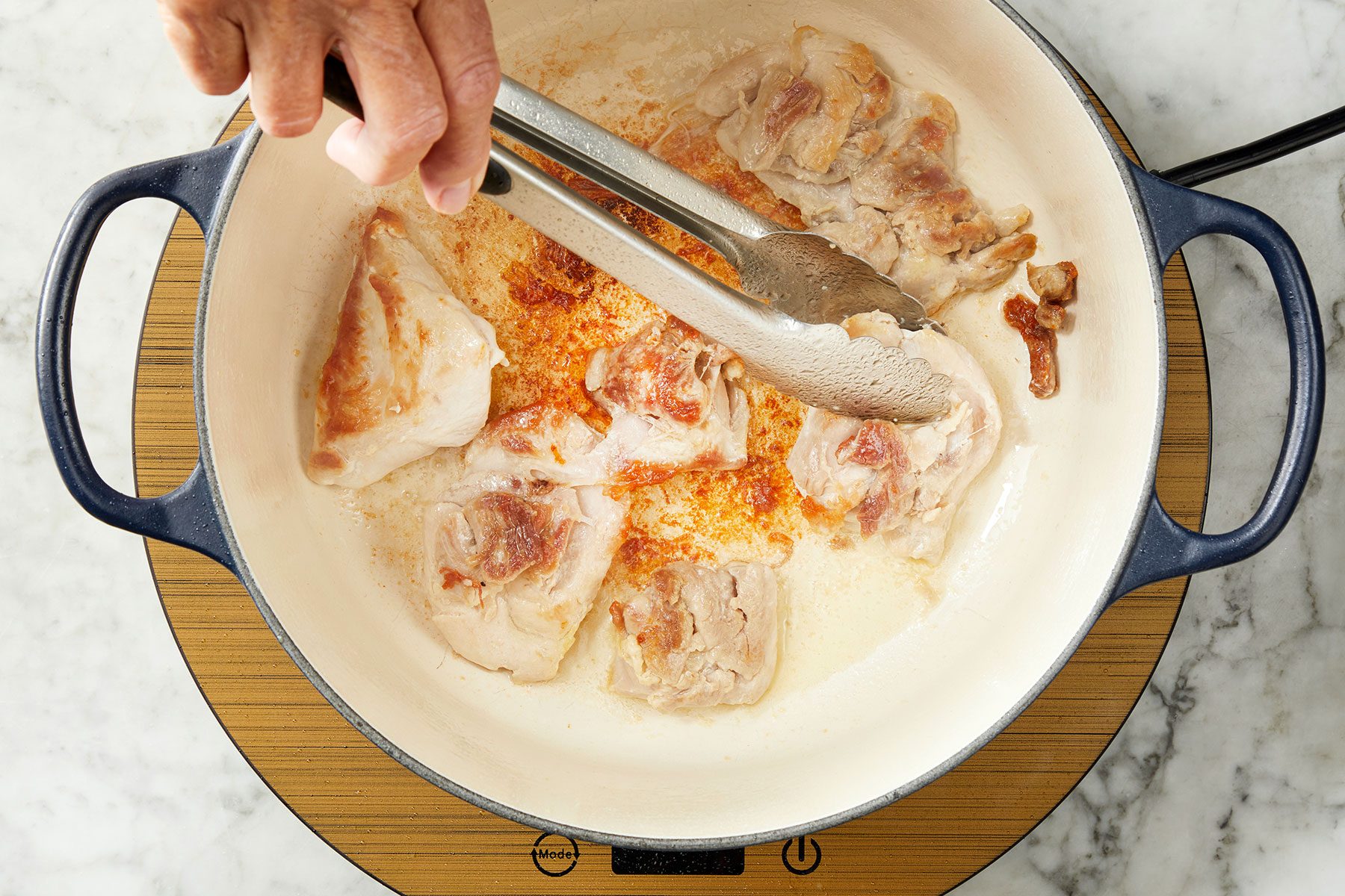 Brown the chicken in batches in medium heated oil in a large Dutch oven.