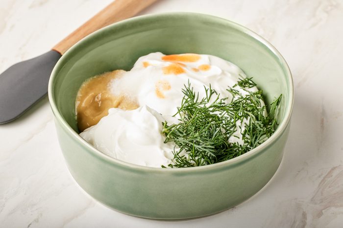 sour cream, yogurt, dill, mustard, salt and hot sauce combined in a bowl