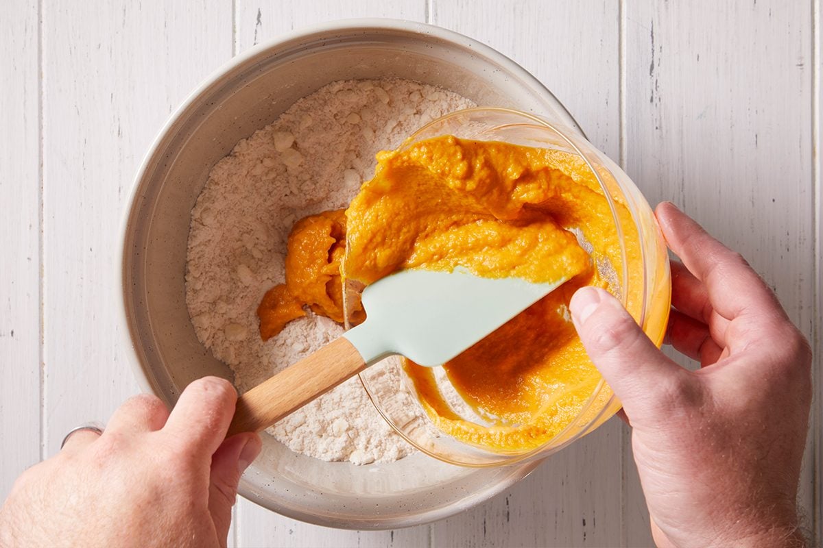Adding a mixture of pumpkin and buttermilk for Pumpkin Biscuits 