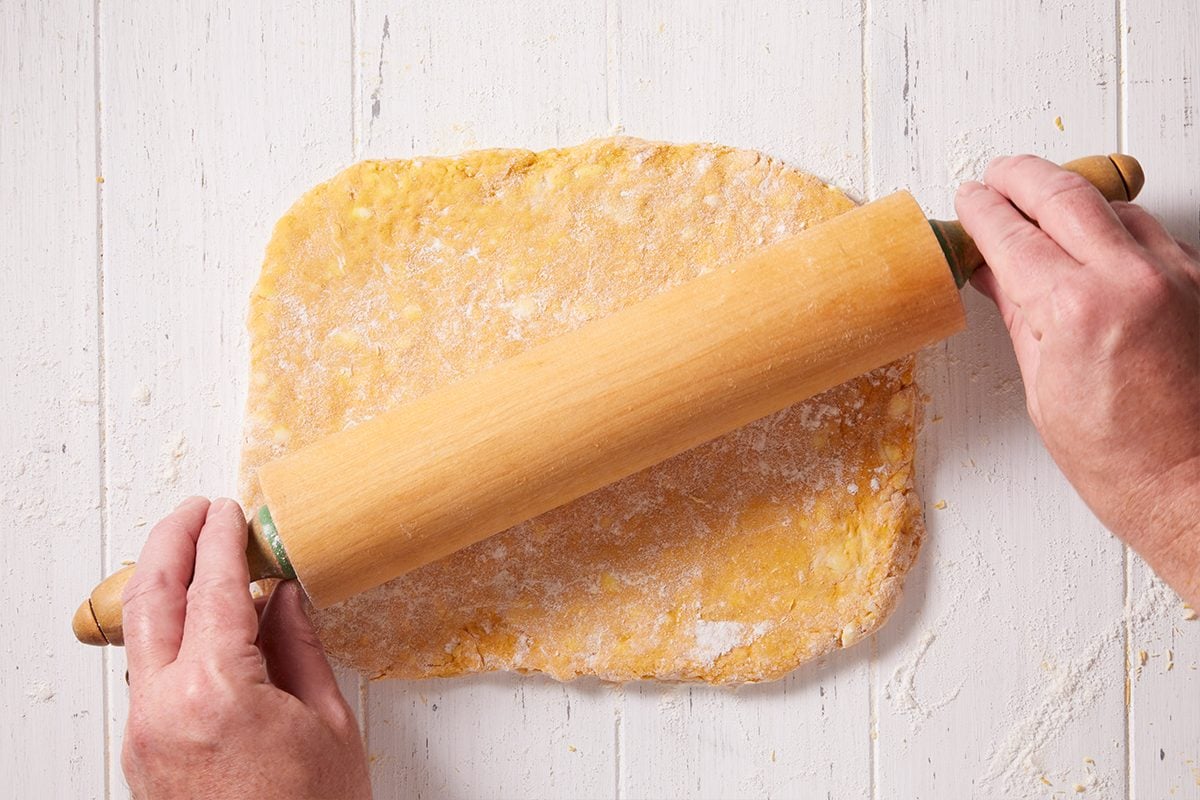 Rolling the dough into 1 inch thickness for Pumpkin Biscuits