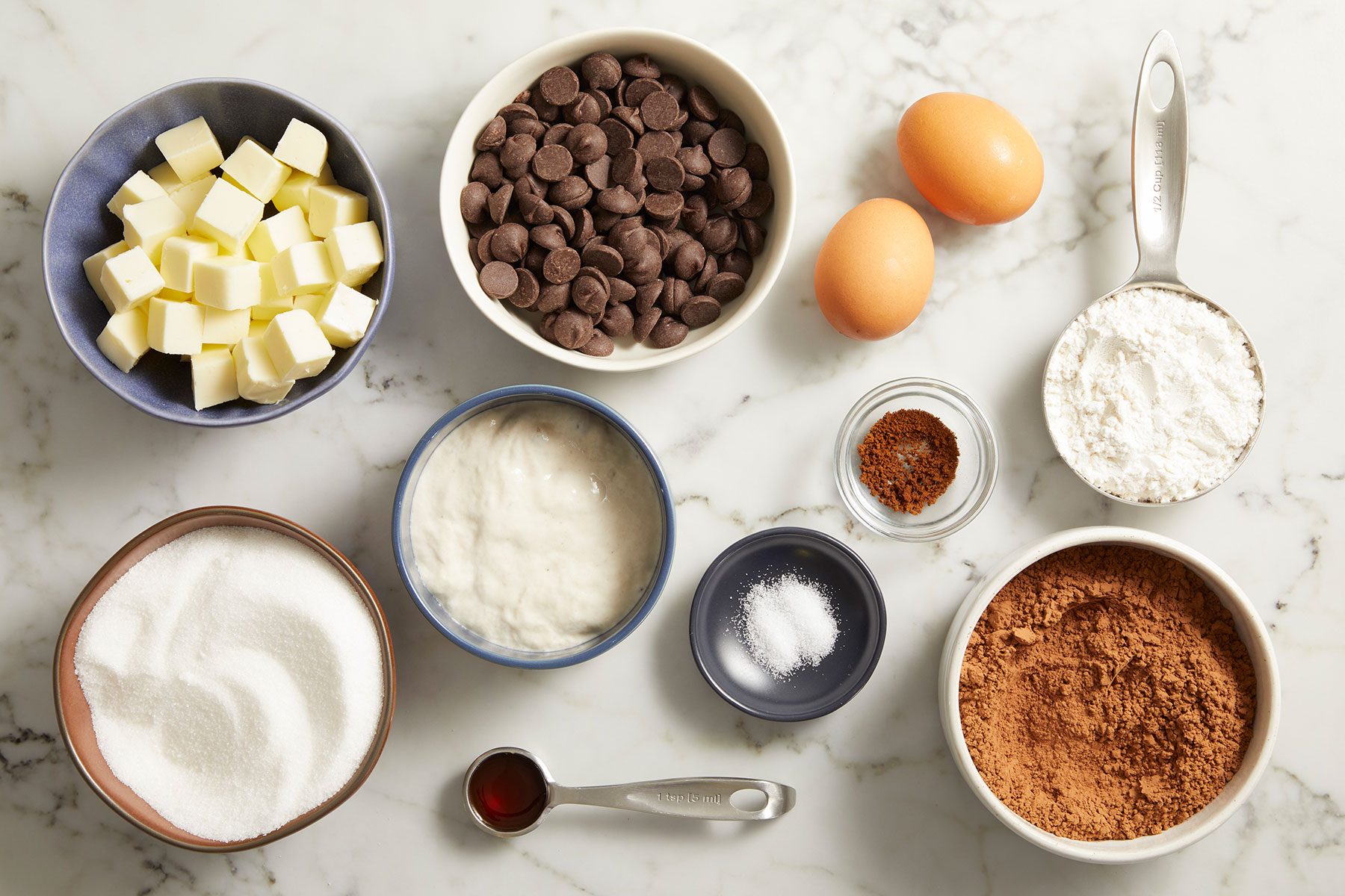 Ingredients for Sourdough Brownies in bowls on a counter.