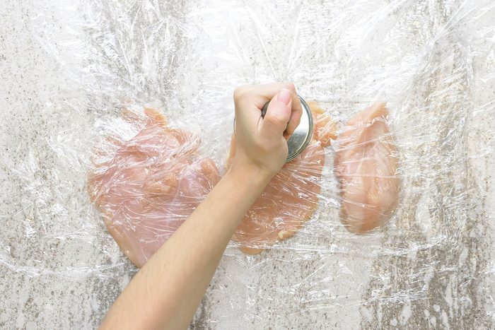Flattening the chicken breasts by placing each piece between two sheets of plastic wrap and use a meat mallet.