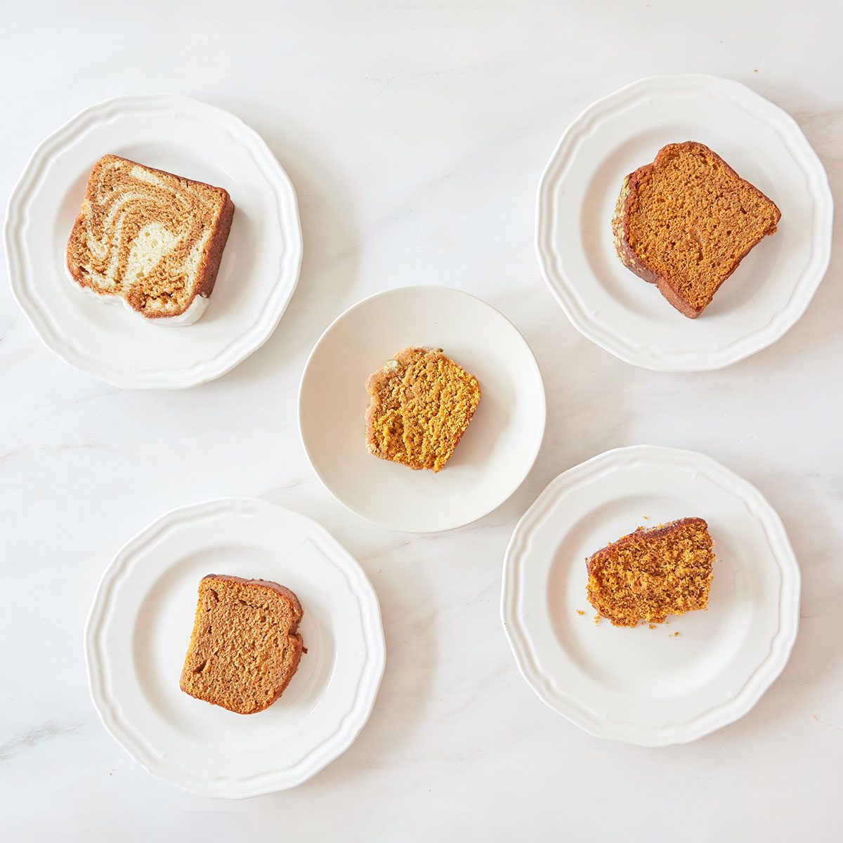 Five different Pumpkin breads served in plates bought from different stores