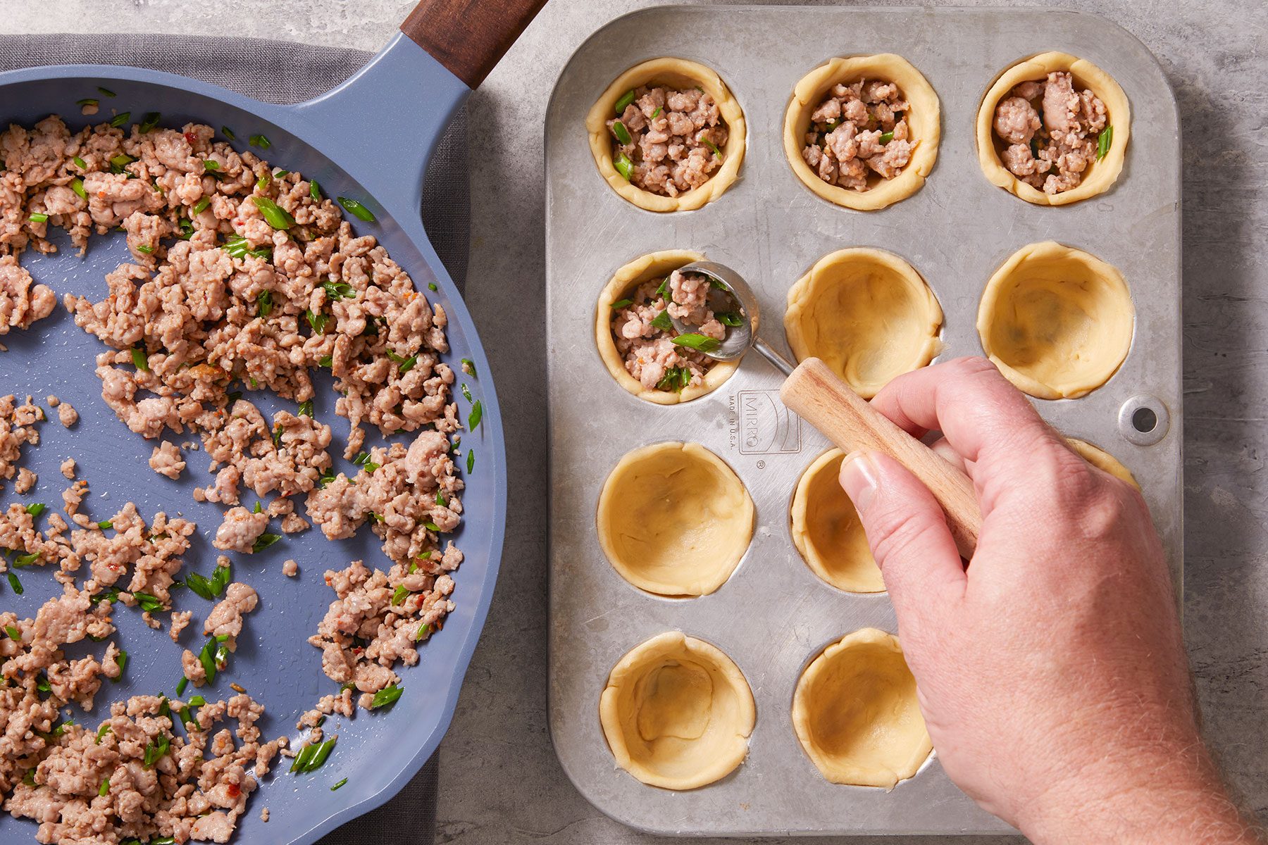 Spooning about 2 teaspoons of the sausage mixture into each crust to make quiches.
