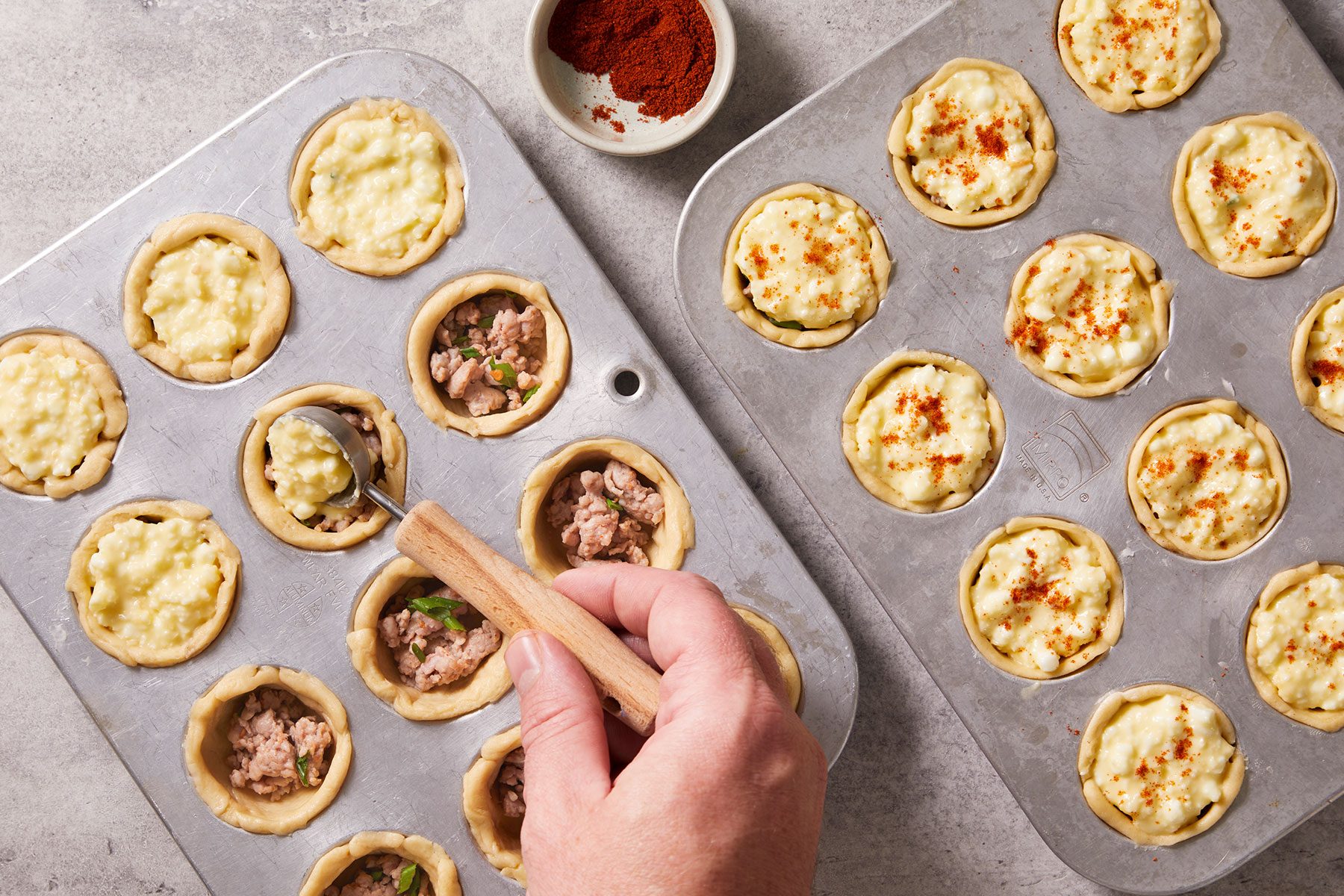 Spooning about 2 teaspoons of the egg mixture into each mini muffin cup, then sprinkling with paprika.