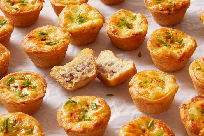 Mini Sausage Quiches on parchment paper.