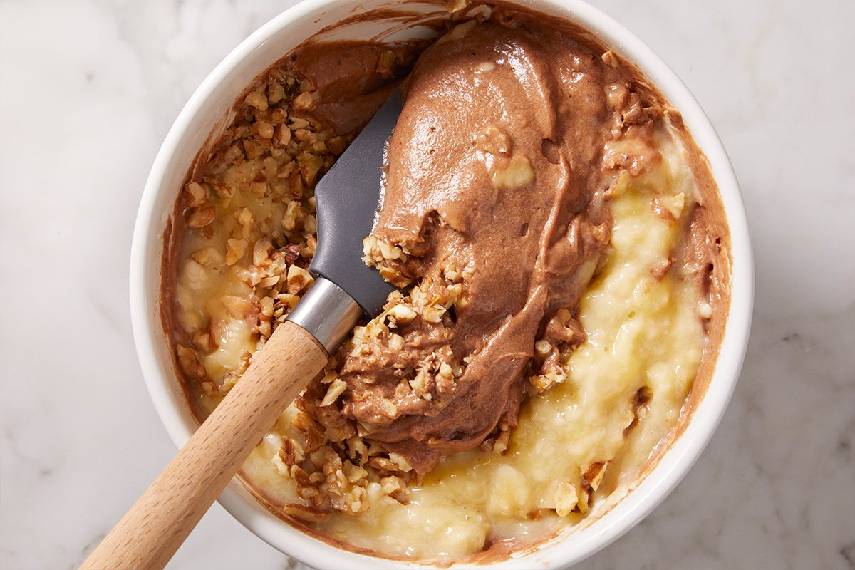 mixing walnuts in brownie batter