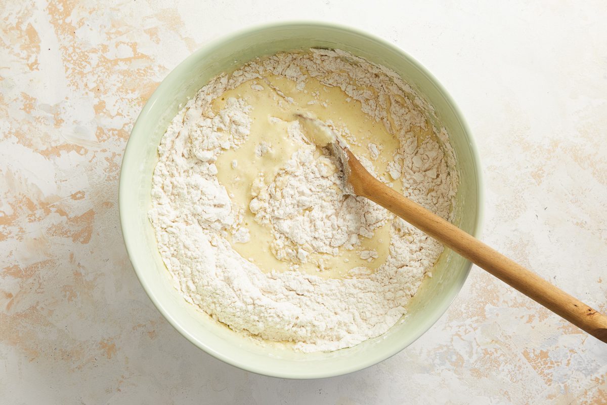 wet ingredients being mixed with dry ingredients