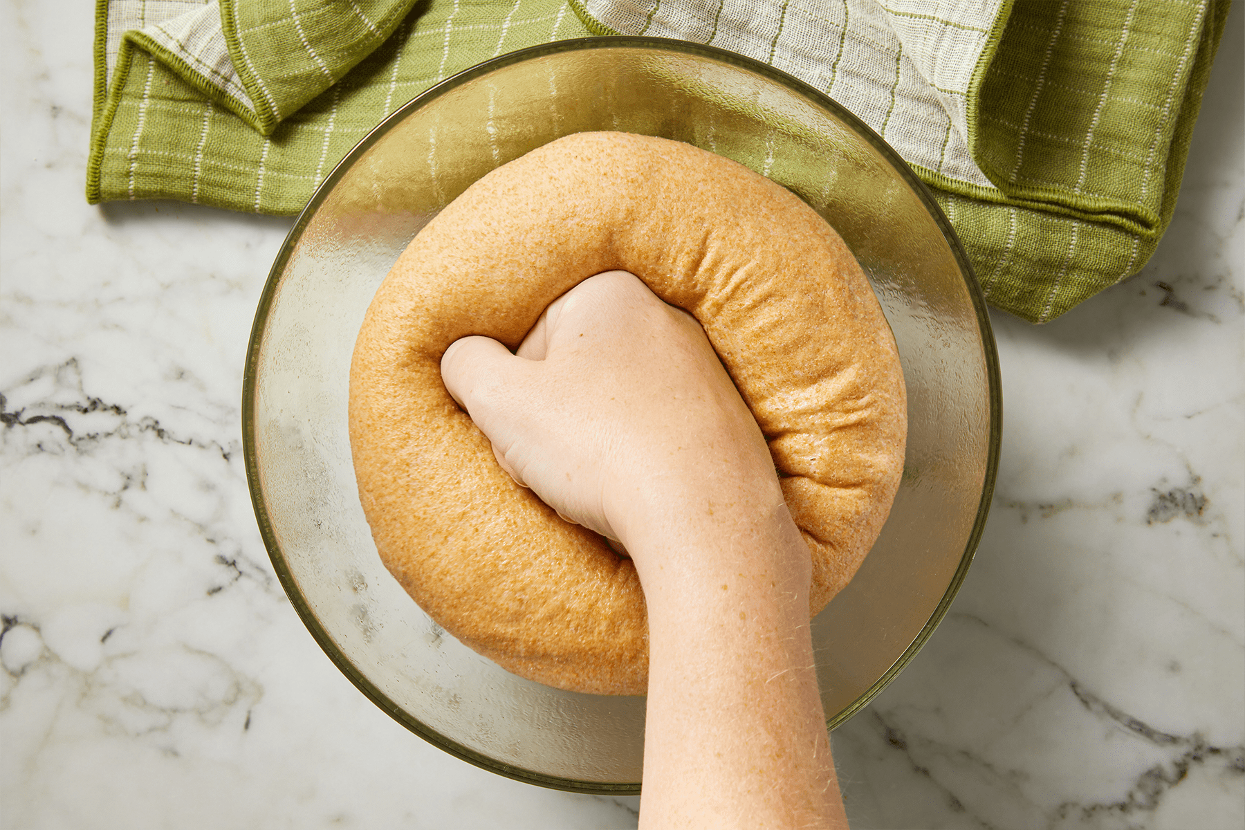 Punching the dough to remove air bubbles