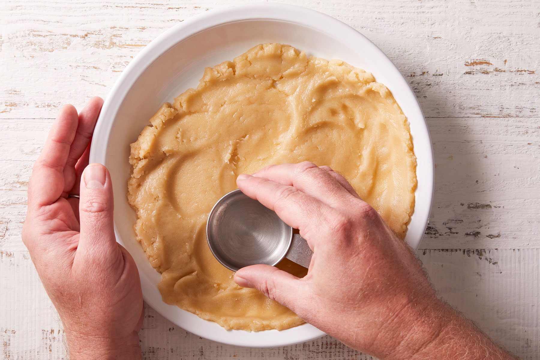Pressing the cherry pie mixture firmly onto the bottom and up the sides of a 9-inch pie plate.