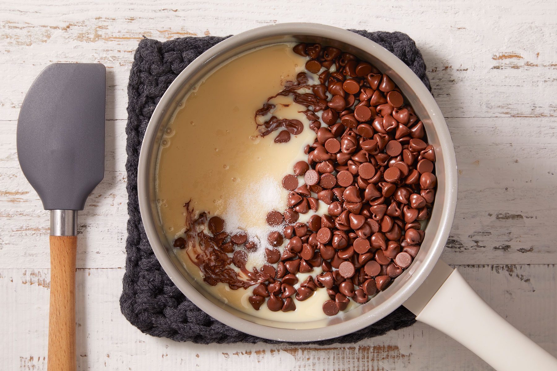 In a saucepan, combining the sweetened condensed milk, chocolate chips and salt and cooking on low flame.